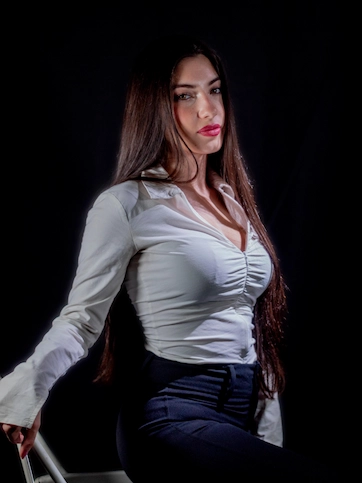 Imágen de actriz fondo negro y camisa blanca